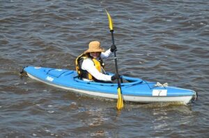 femme au chapeau en canoe-kayak